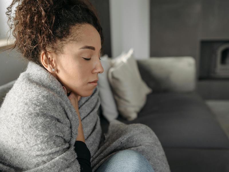 Woman suffering in a room that is too cold